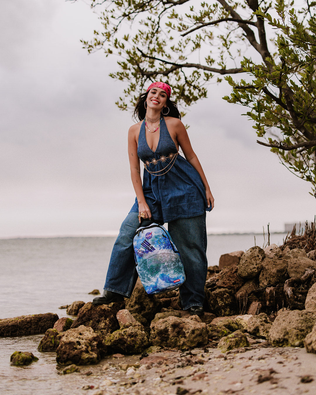 Sprayground NASA Collaboration Limited Edition Laptop Backpack in pink, with its interior laptop compartment and mesh organizer pocket visible.