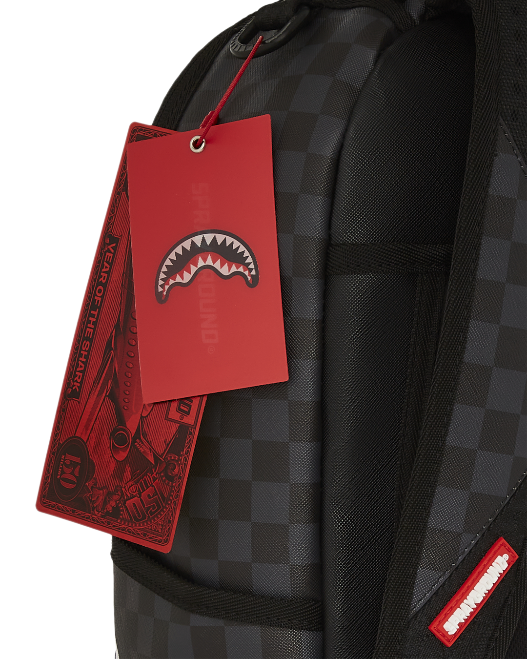 Superman faux leather backpack displayed on a wooden bench, showcasing front pockets.