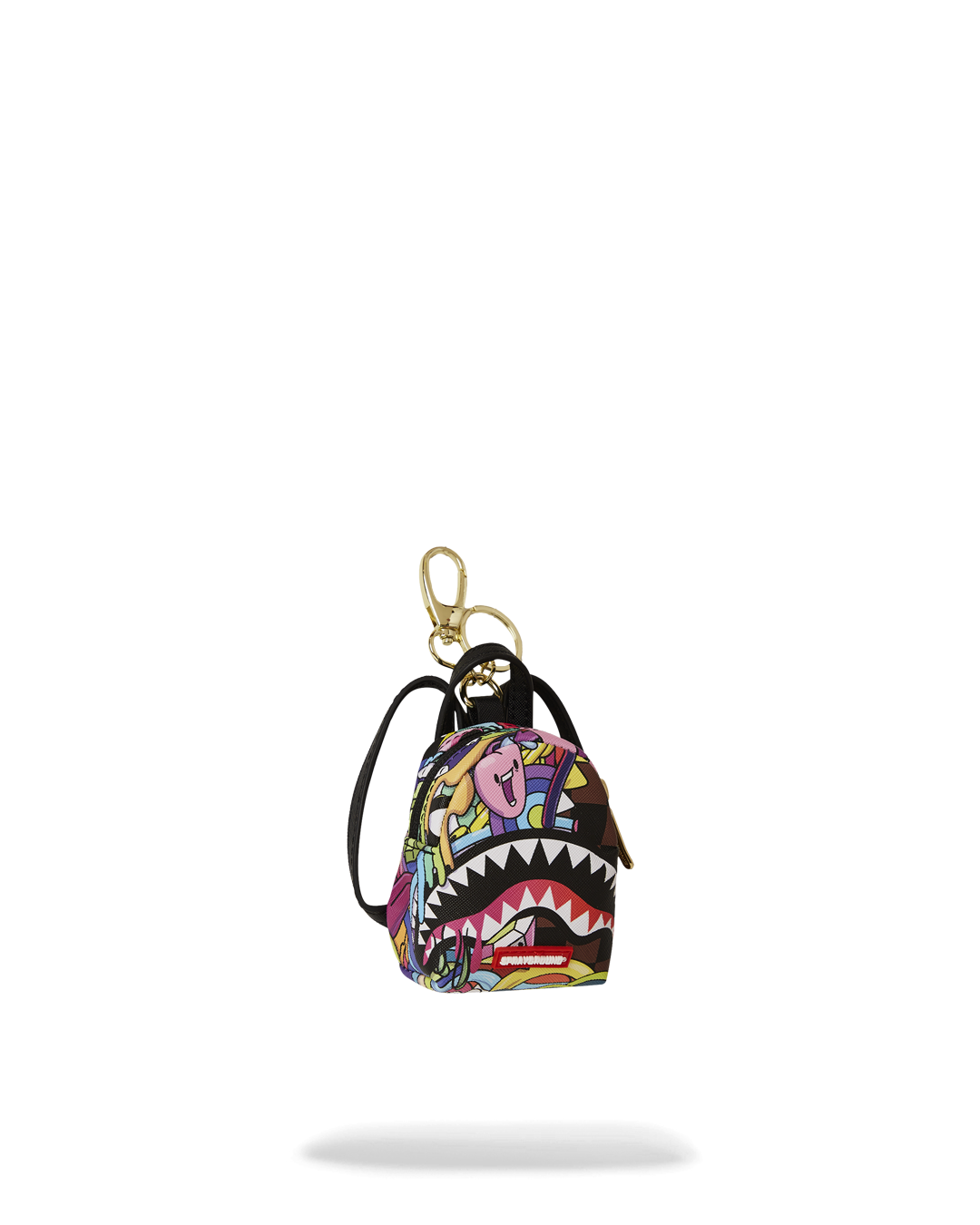 The keychain mini backpack being used to store small items like coins and headphones.