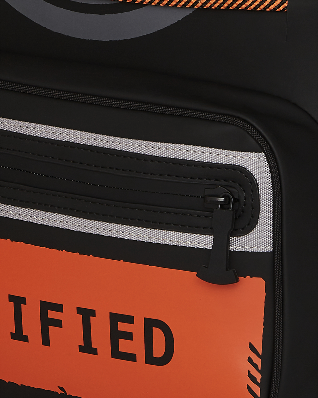 Close-up of gold zippers and metal hardware on the backpack