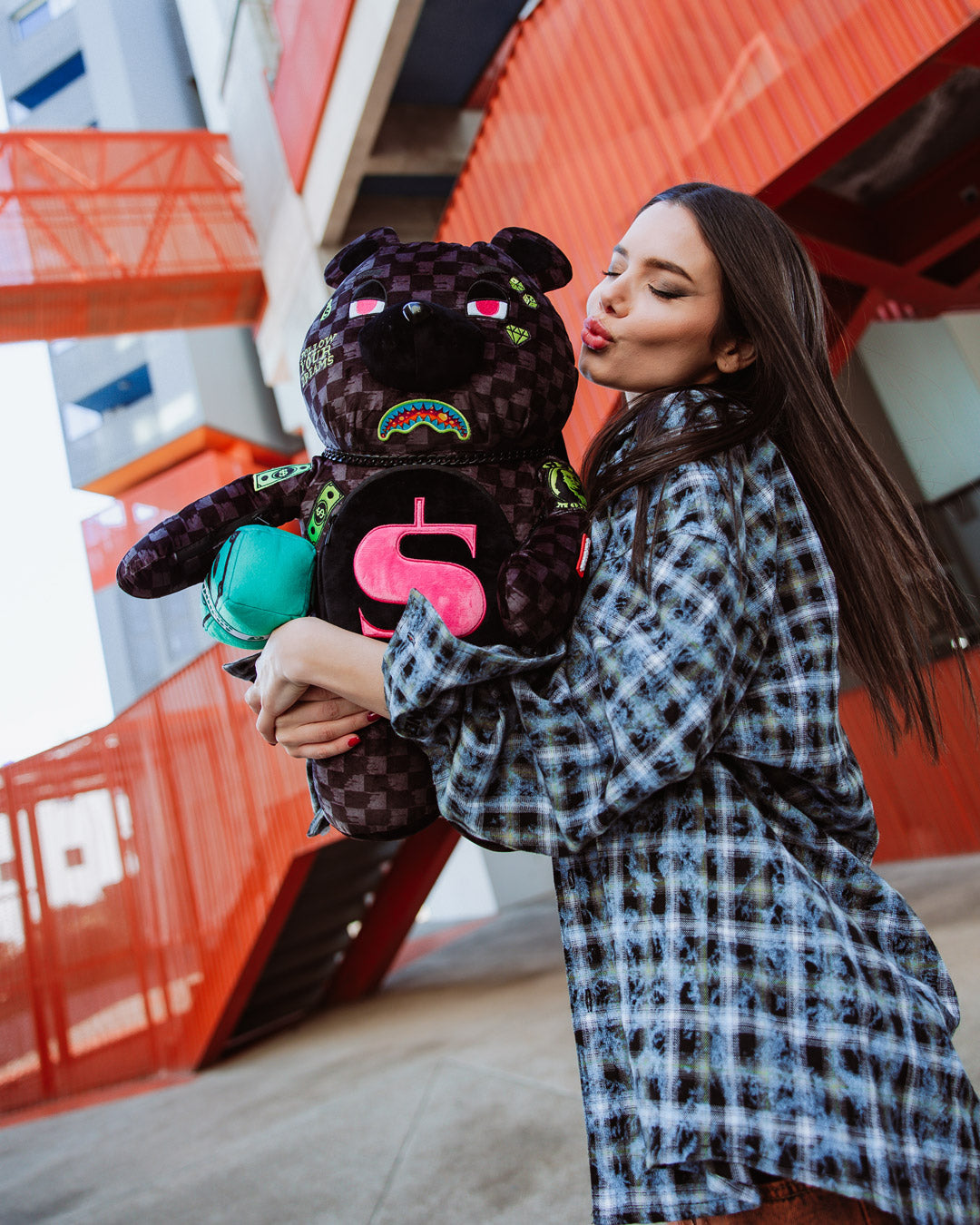 Side view highlighting the zippered arm pockets on the sprayground backpack money bear.