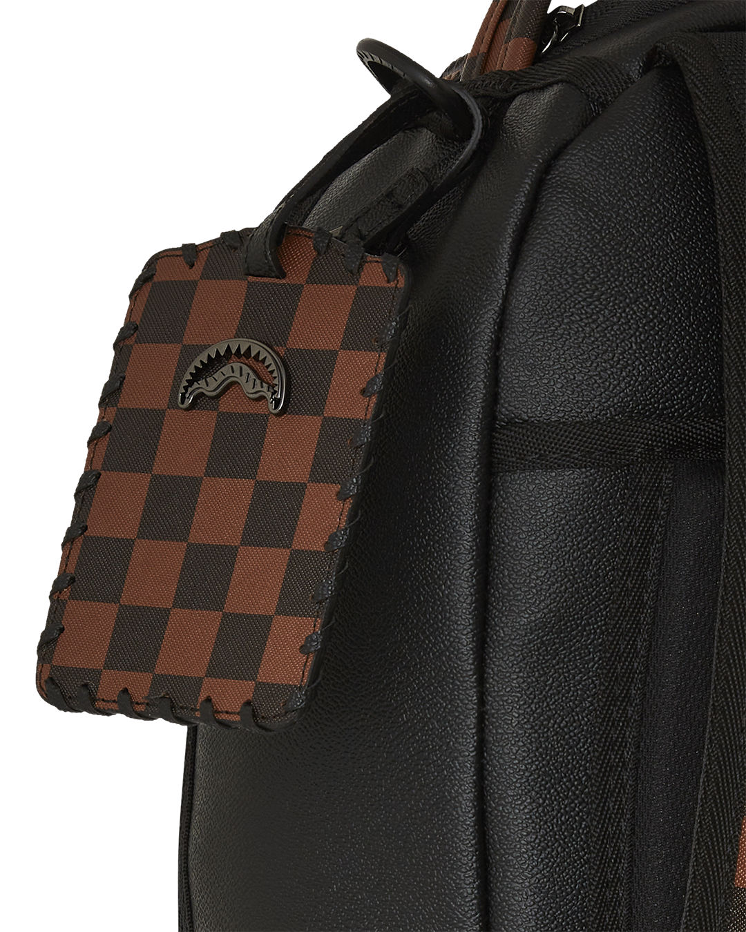 Close-up of embossed sharkmouth detail on faux leather backpack