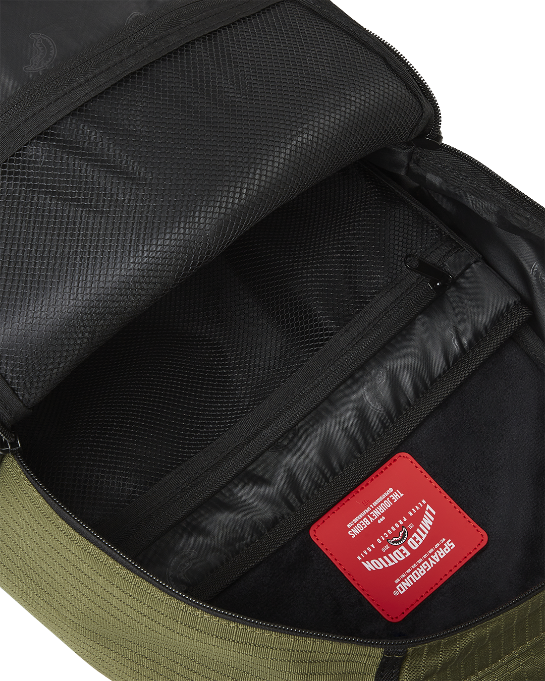 Open laptop compartment revealing velour lining and mesh pocket