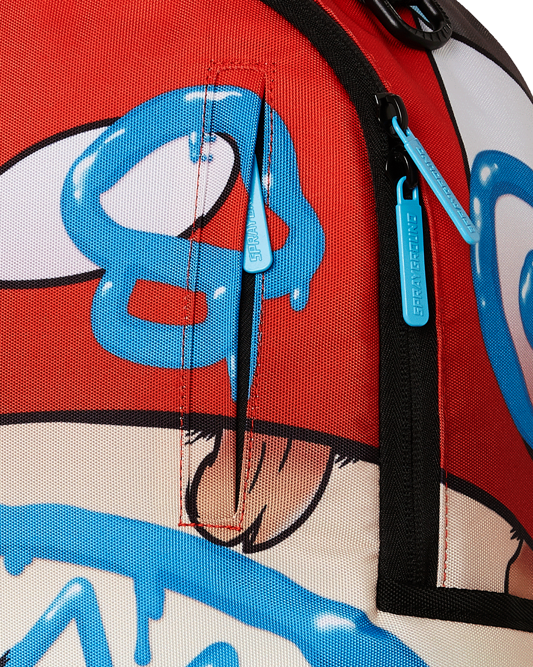 Close-up of gold zippers and Sprayground badge on the artist-style backpack.