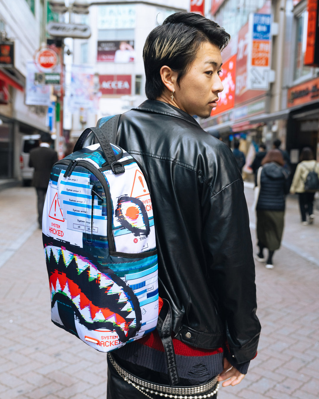 Side view showcasing the mesh organizer pocket of the luxury backpack.
