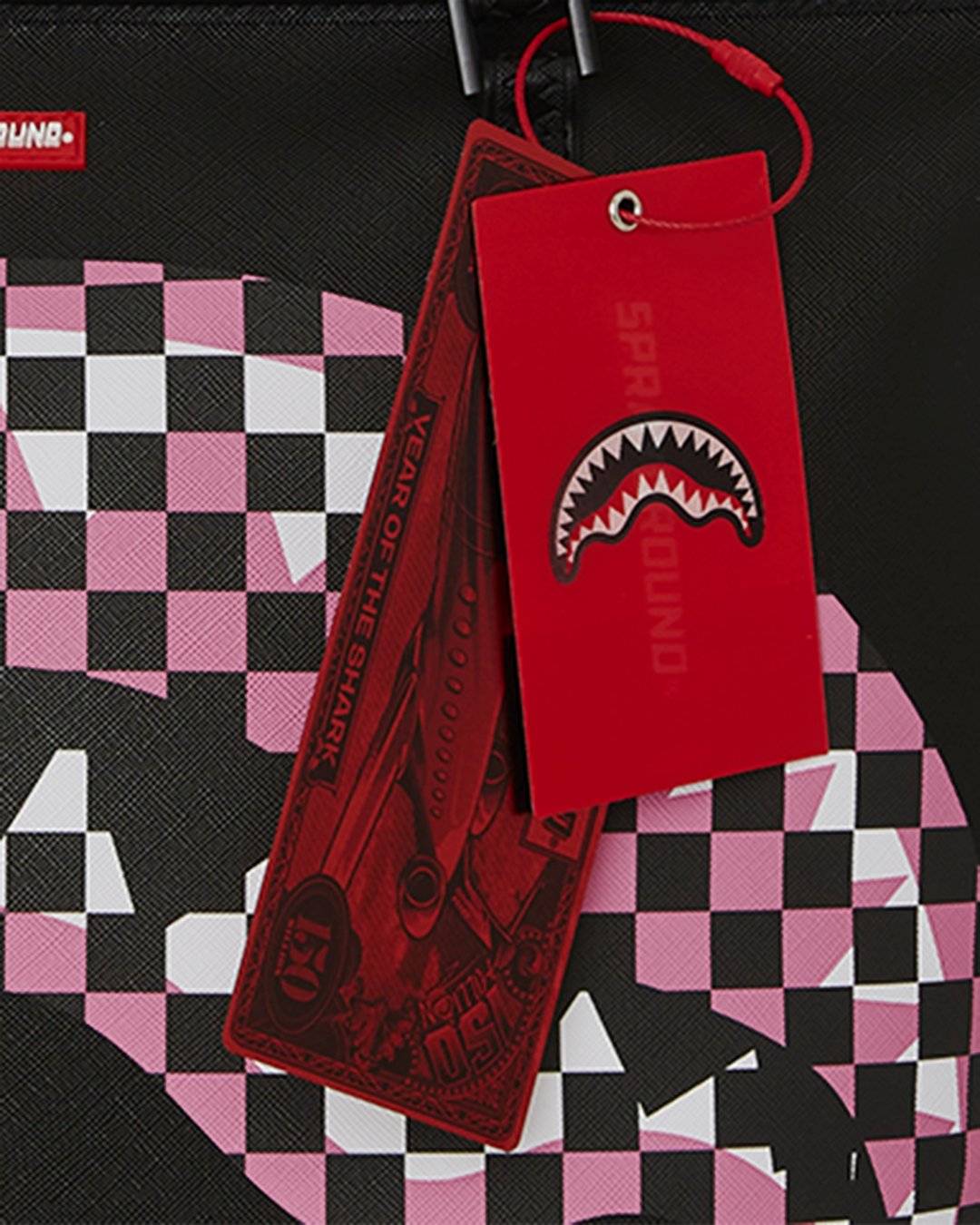 Close-up of shark print design on black faux leather tote bag