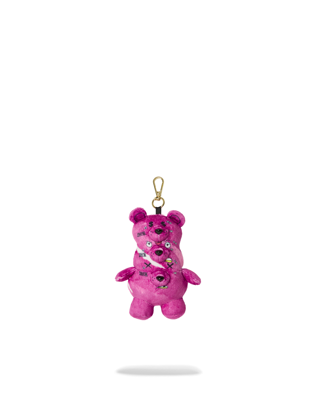 Front view of the triple pink bear plush keychain on a table.