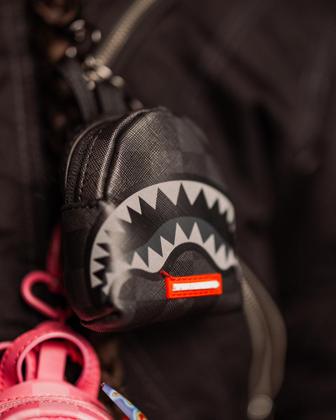 Paris-themed shark keychain on a denim jacket pocket