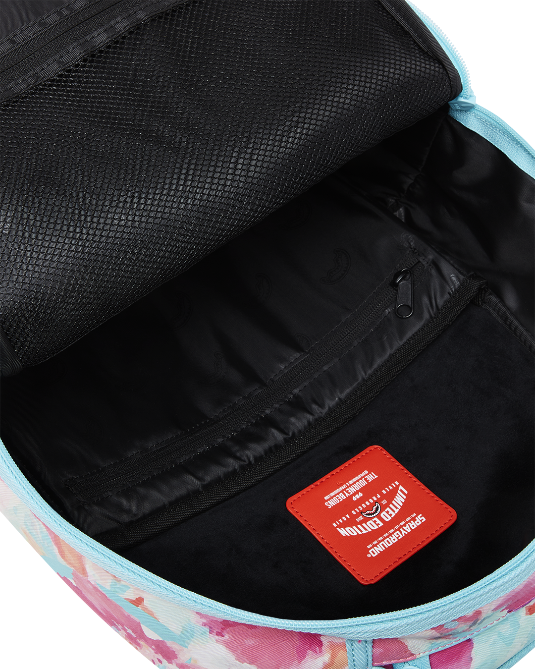 Angled view showing gold zipper detailing on faux leather backpack