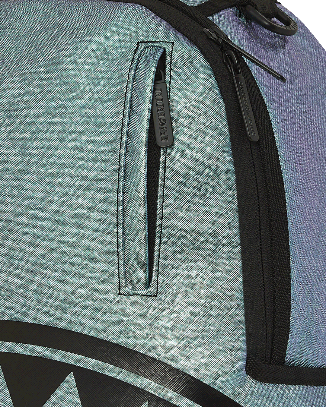 Small faux leather backpack worn crossbody in urban setting