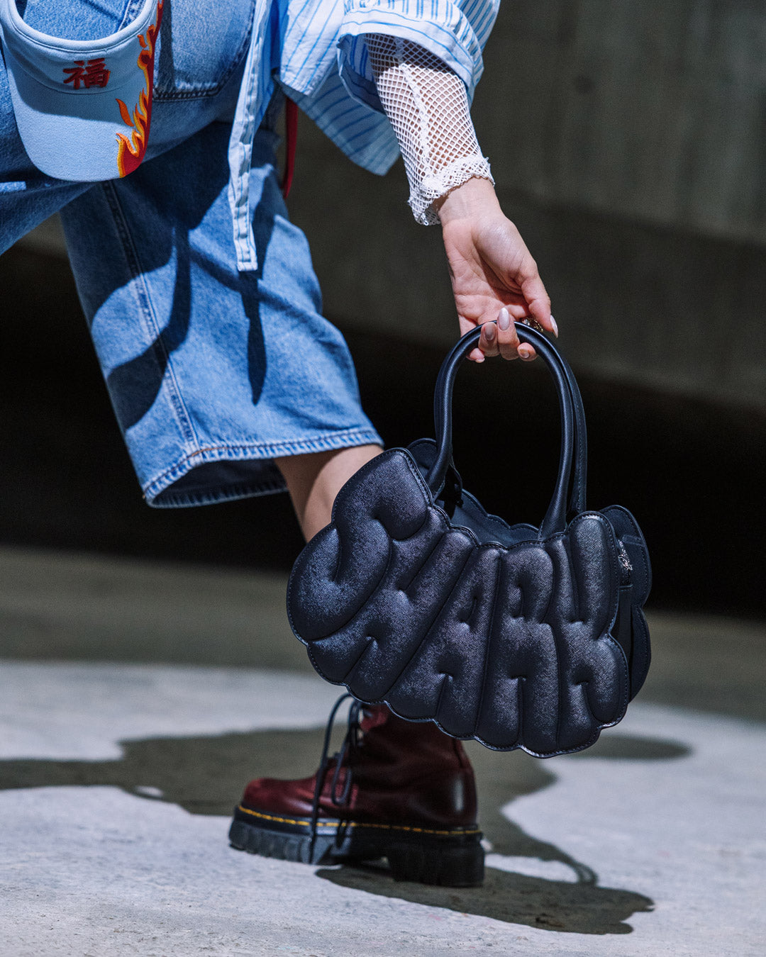 Front view of the Shark Edge handbag showing its saffiano texture and industrial studs