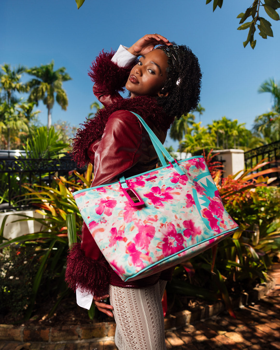 Front view of the printed tote bag featuring floral artwork and top double handles
