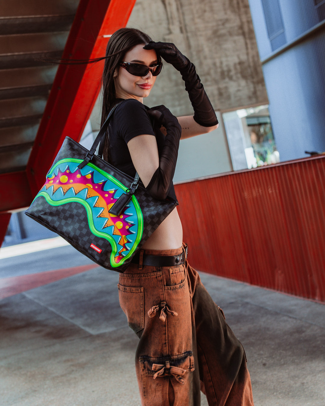 Sprayground tote bag being carried over the shoulder, showcasing its stylish design
