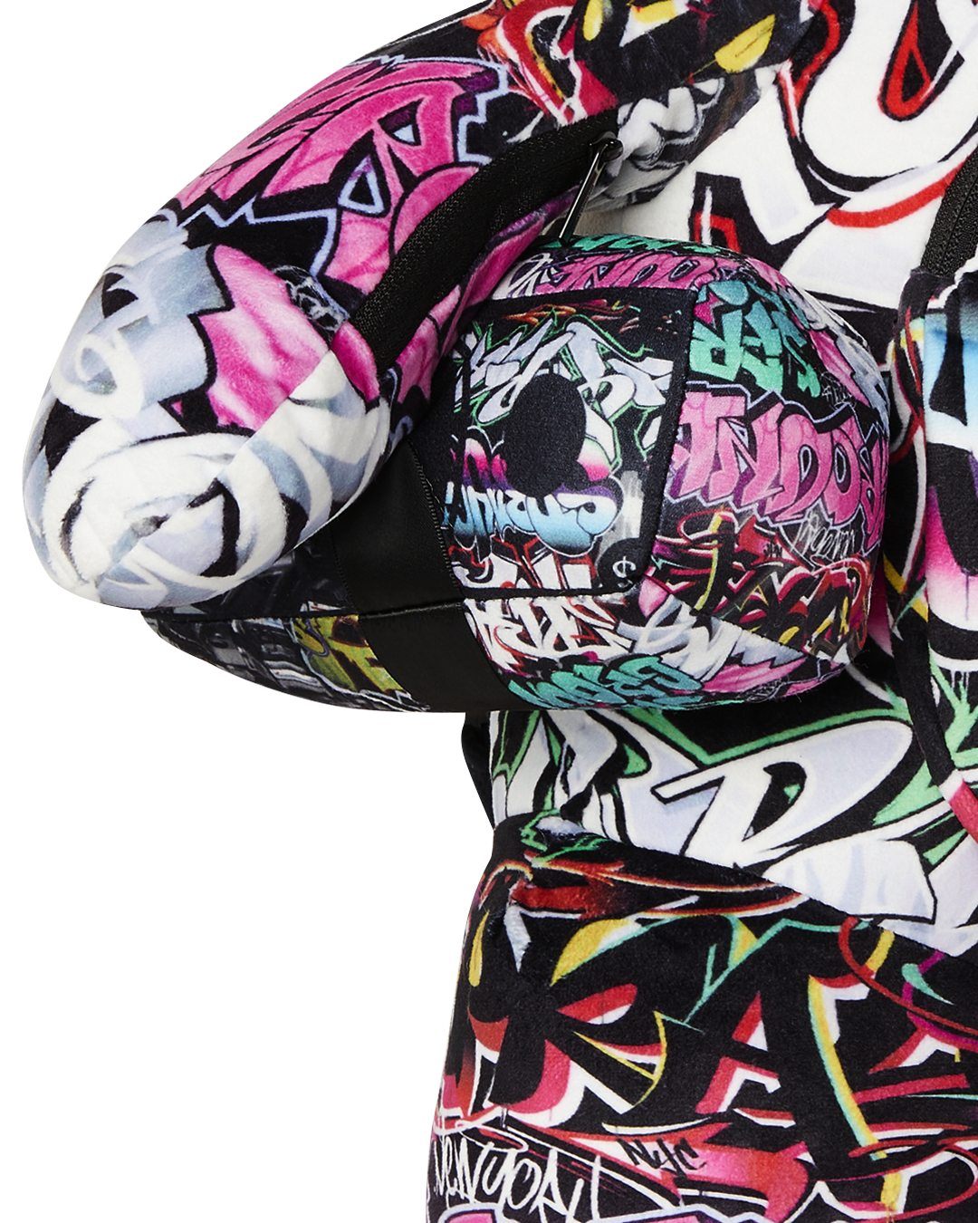Side angle of plush backpack highlighting arm zipper and strap adjustment