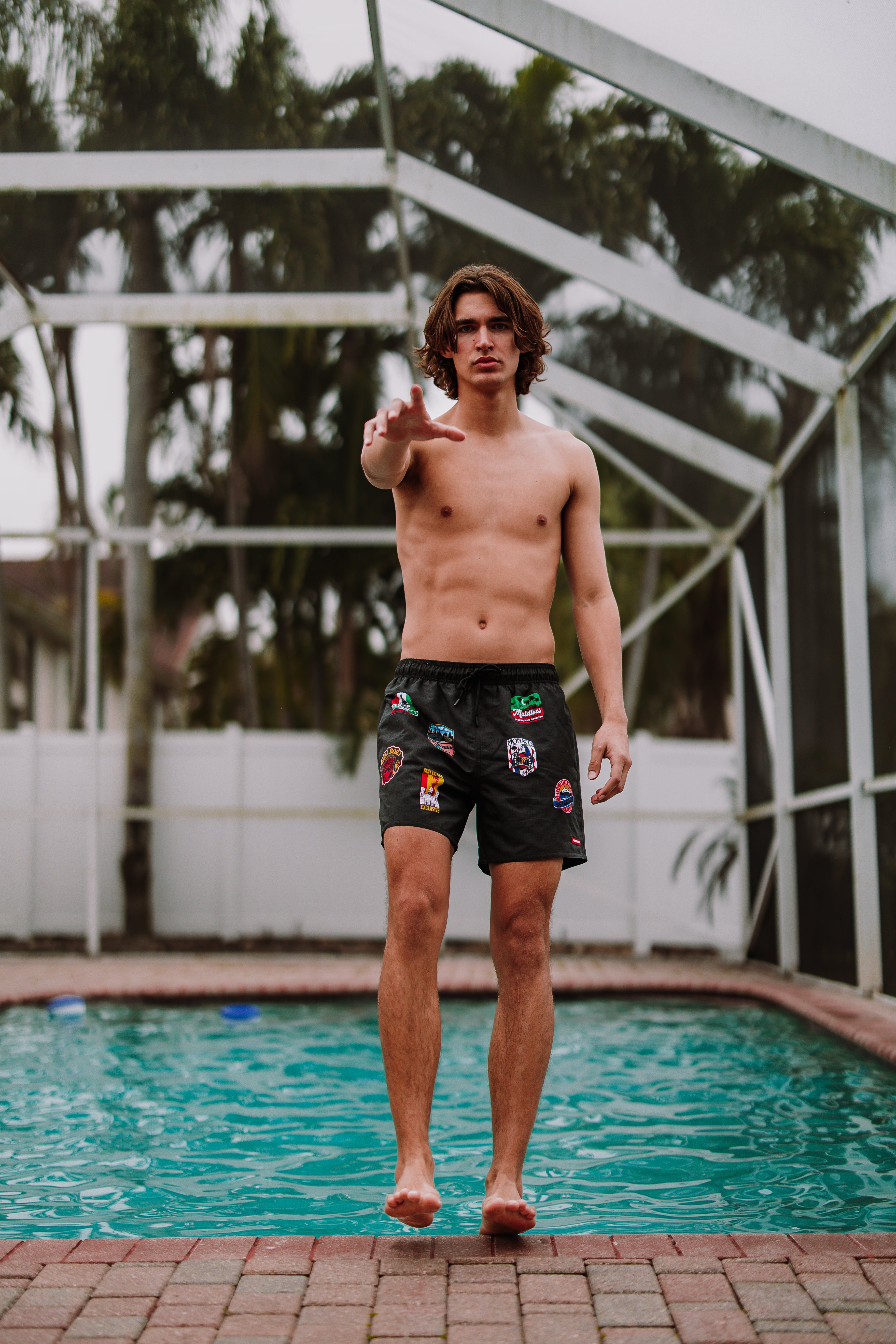 Mens luxury swim shorts with side pockets and branded elastic waistband