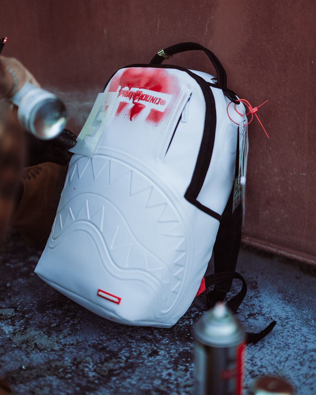 Side view of designer bag showing pockets and ergonomic straps