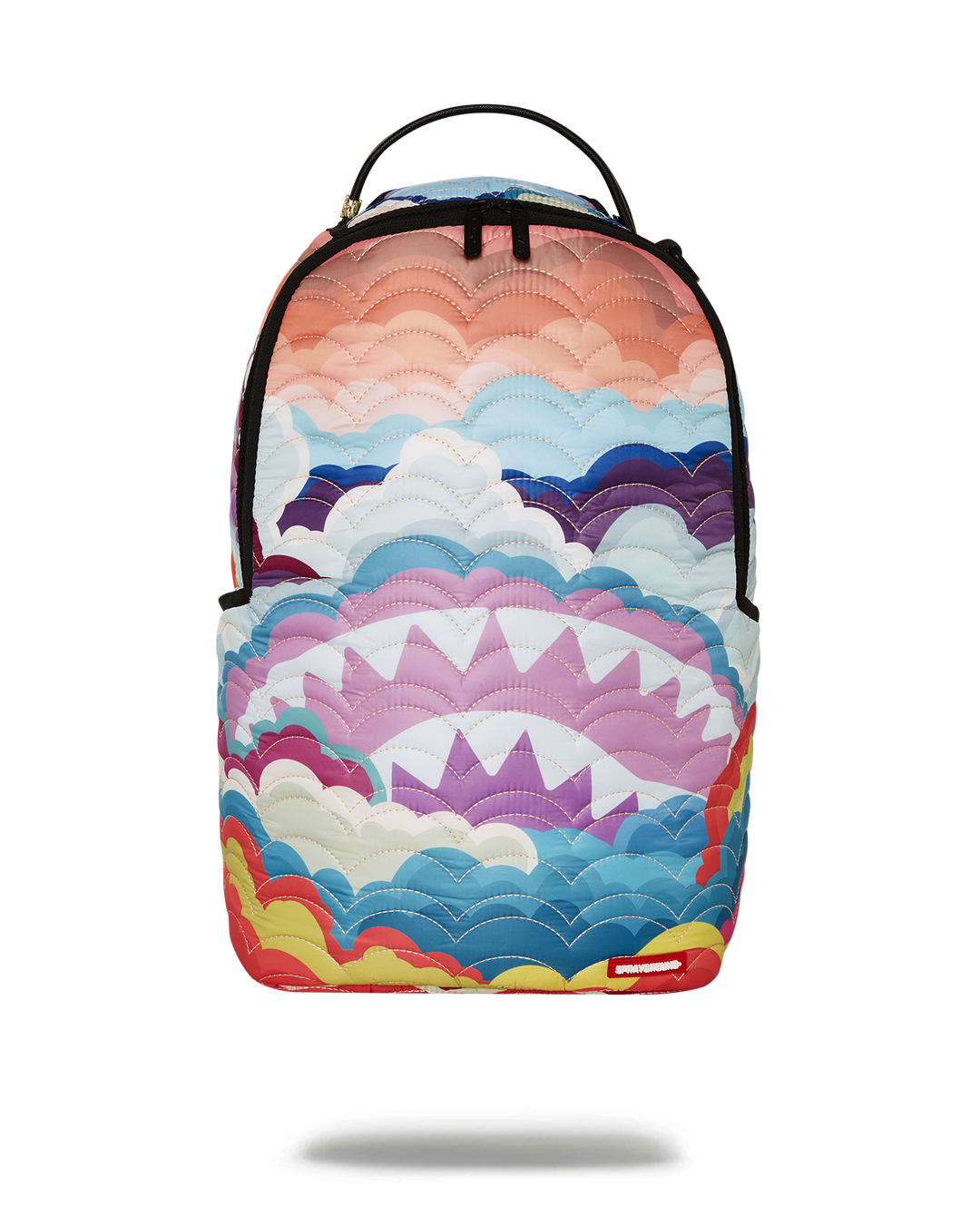 Rainbow quilted backpack worn over shoulders, showcasing cloud detailing and side pockets