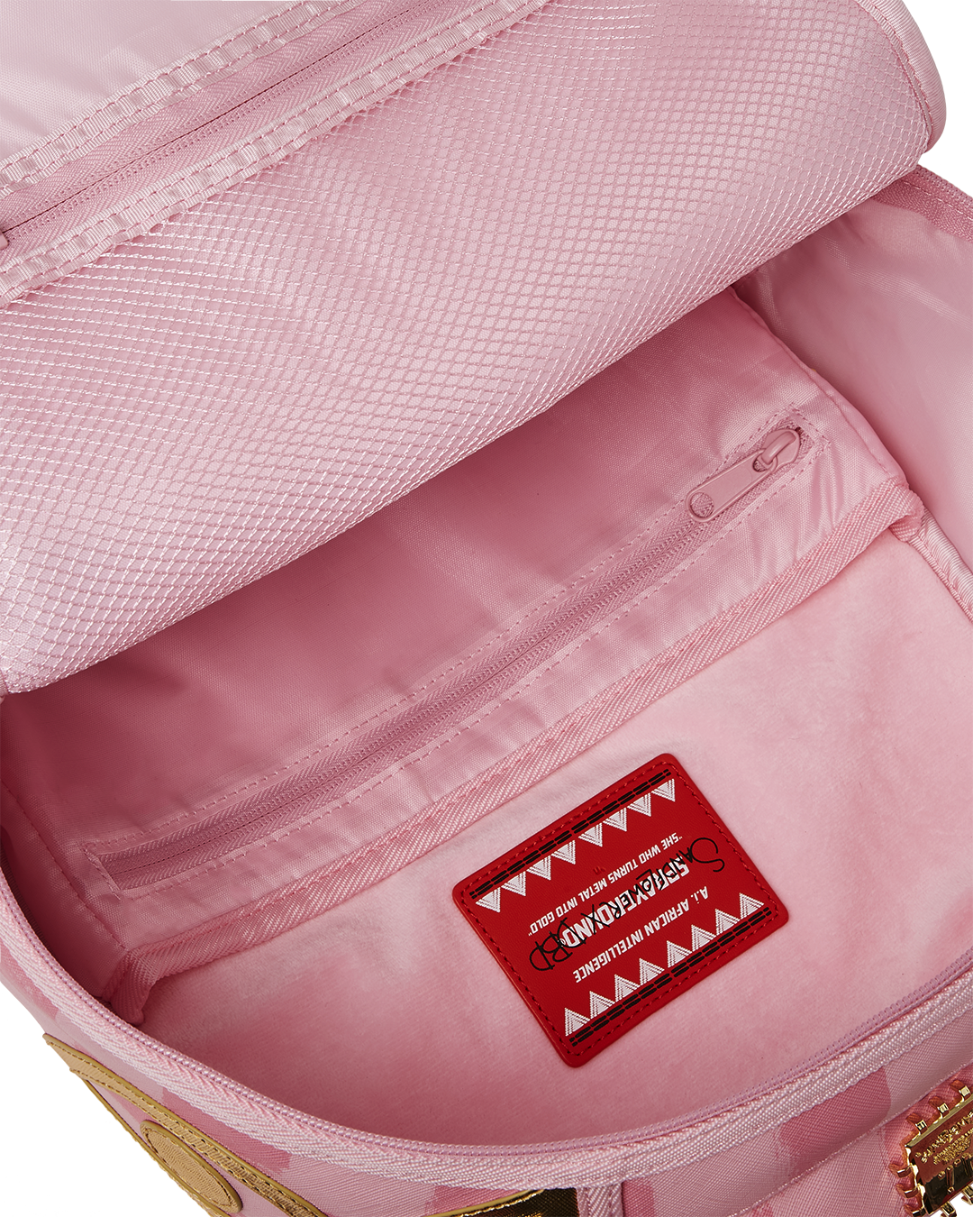 Interior shot of the Sprayground backpack featuring a laptop compartment and mesh organizer