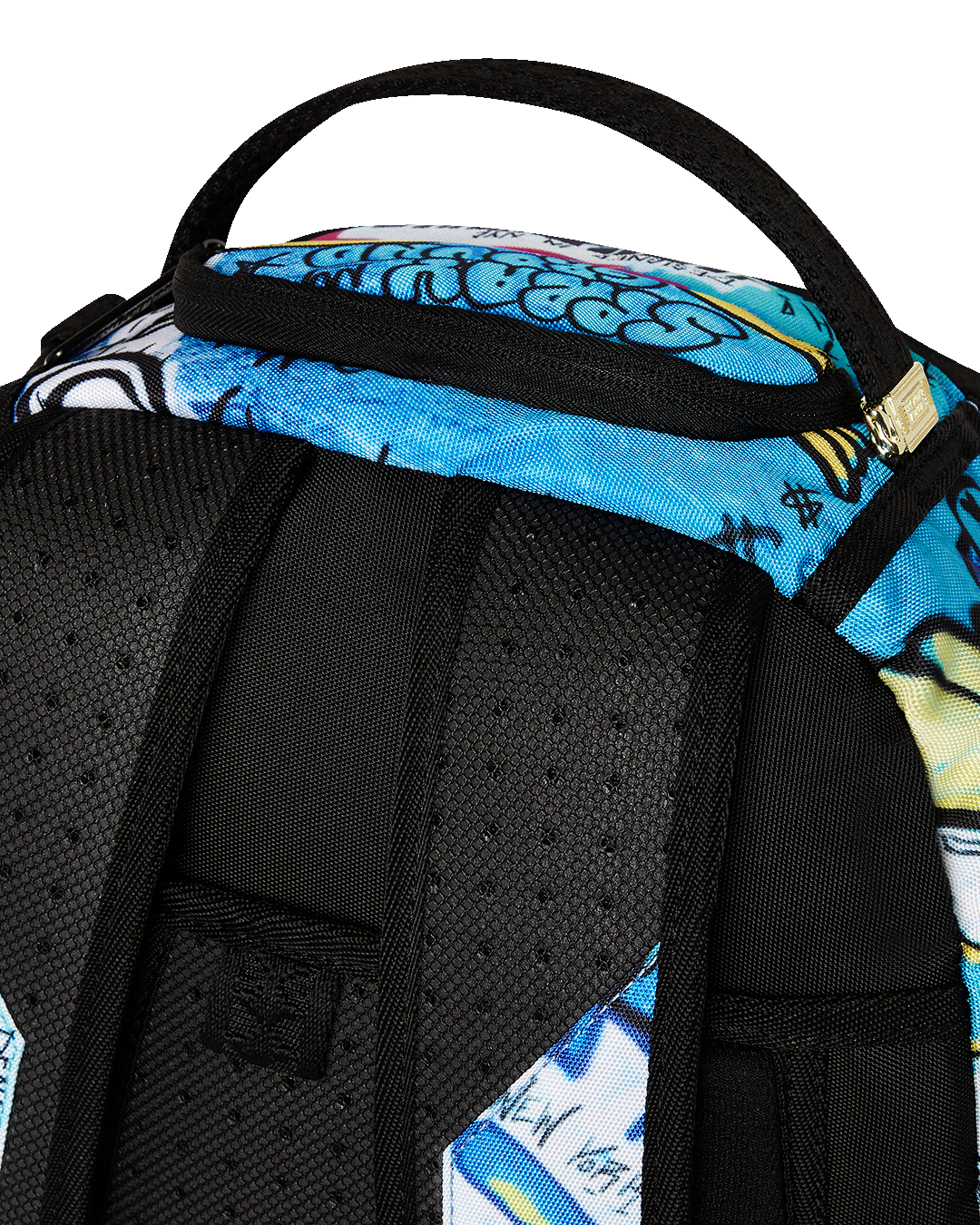 Close-up of the backpacks front zipper pocket and gold hardware for travel organization