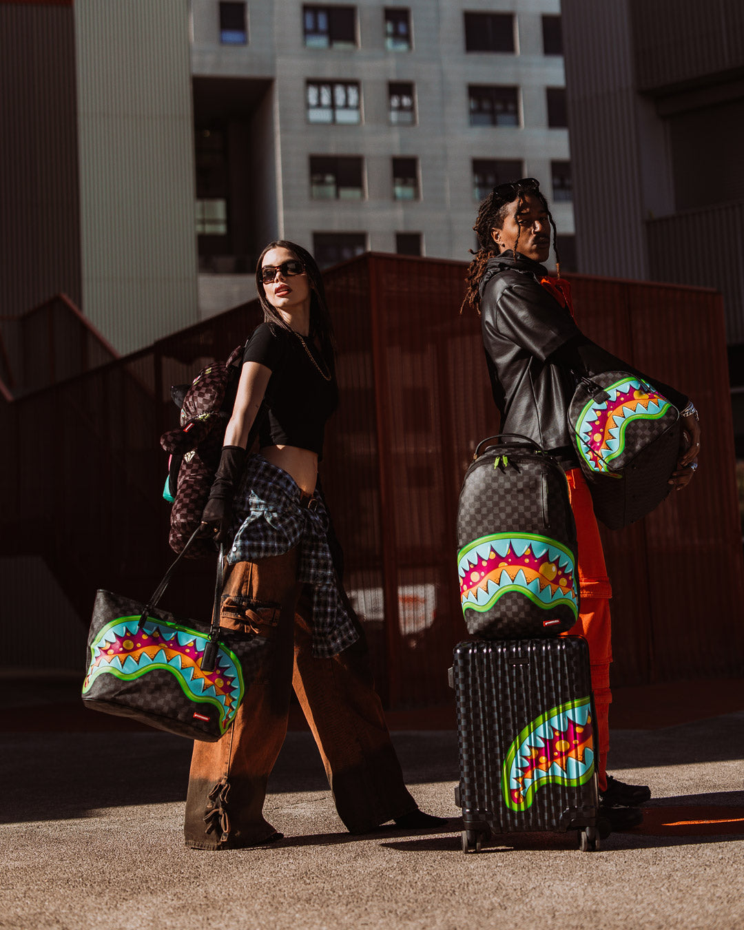 Traveler using hard shell carry-on luggage at the airport.