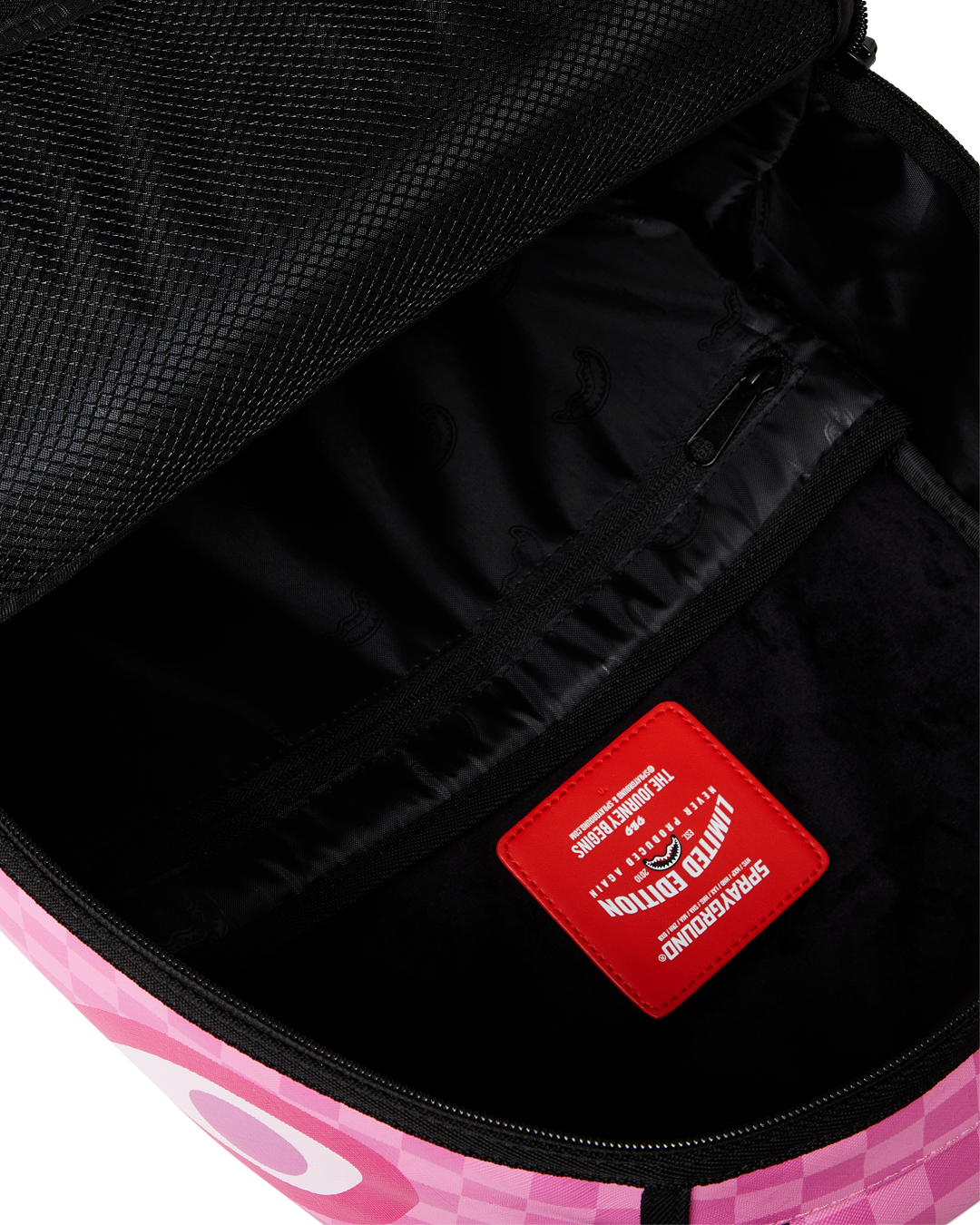 Side view of faux leather backpack showing ergonomic straps and velour lining.