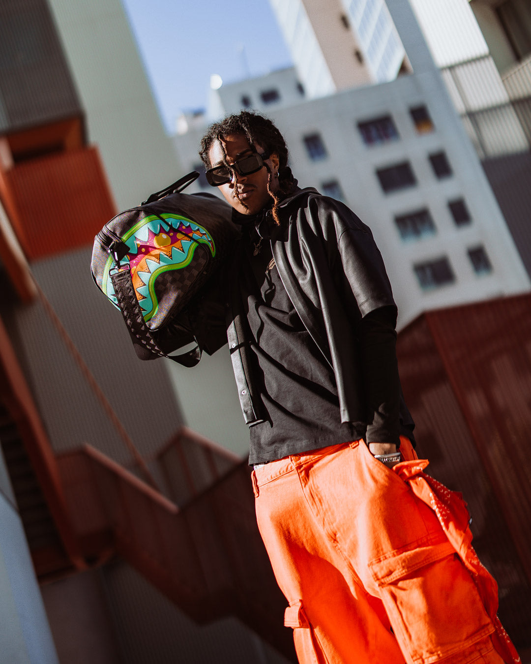 Close-up of Sprayground slime duffle bag’s gold zippers and faux leather texture