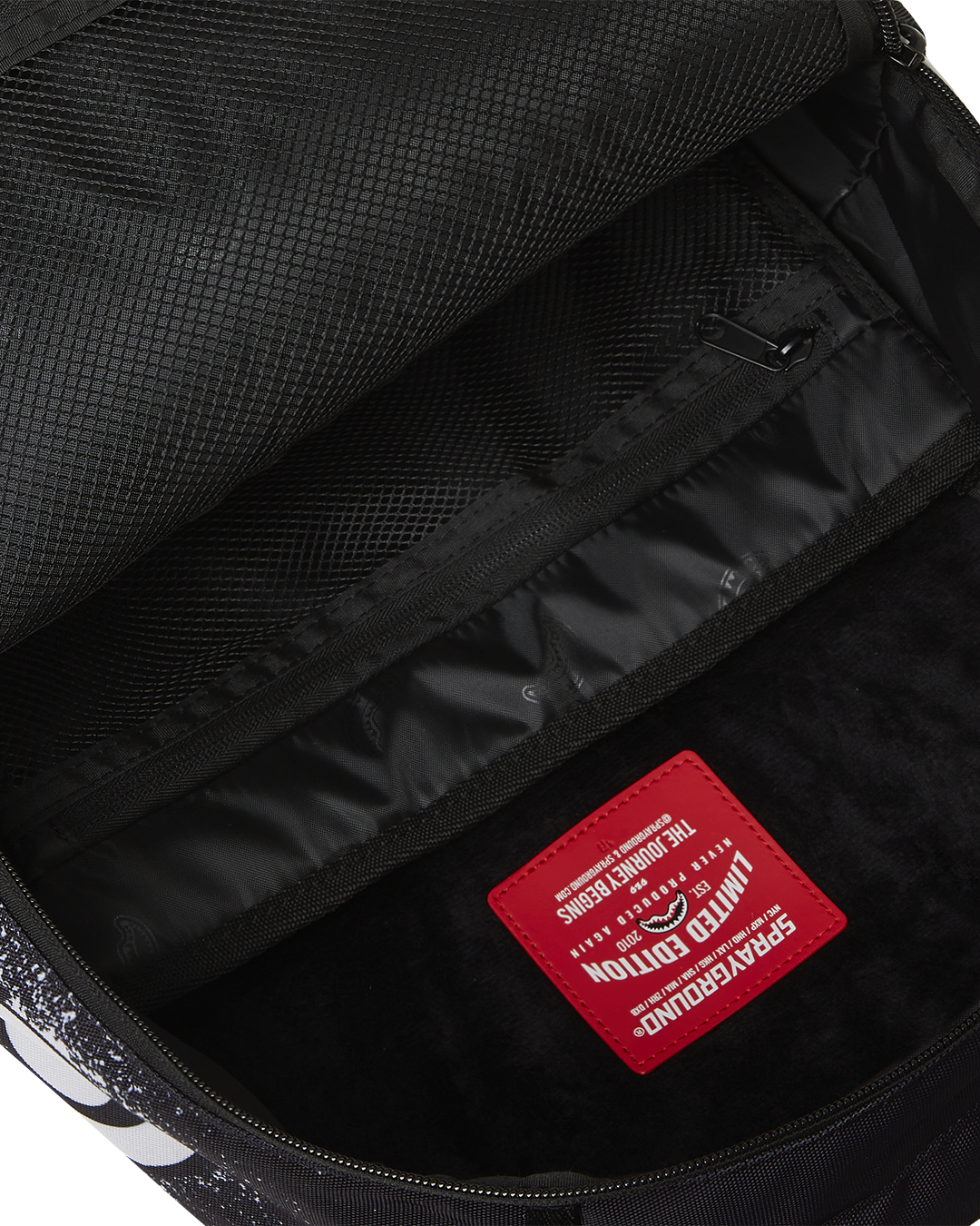 Side angle showing adjustable straps and Sprayground badge