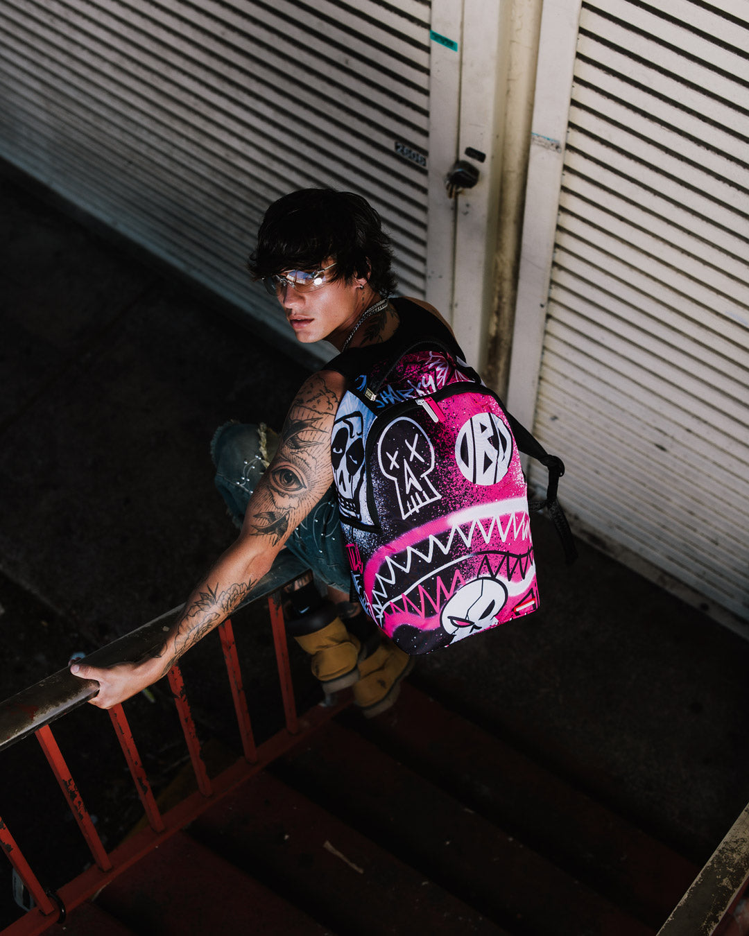 Peak Design Backpack DLXR being worn, demonstrating its ergonomic mesh back padding and adjustable straps.