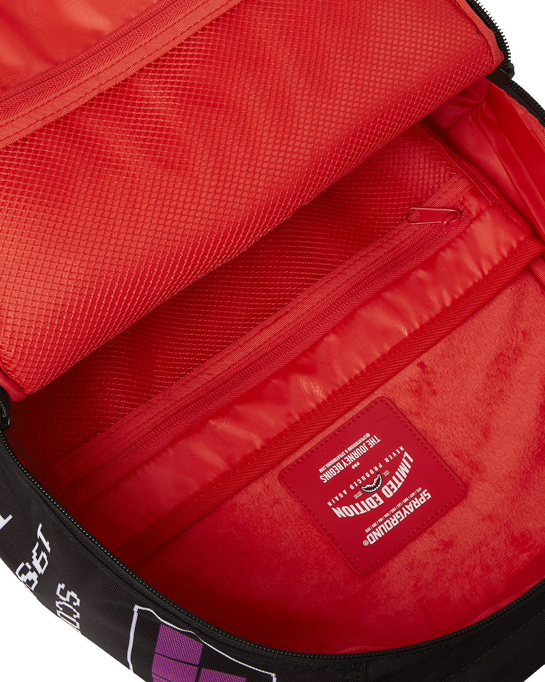 Side view highlighting adjustable straps and pink details on Sprayground backpack