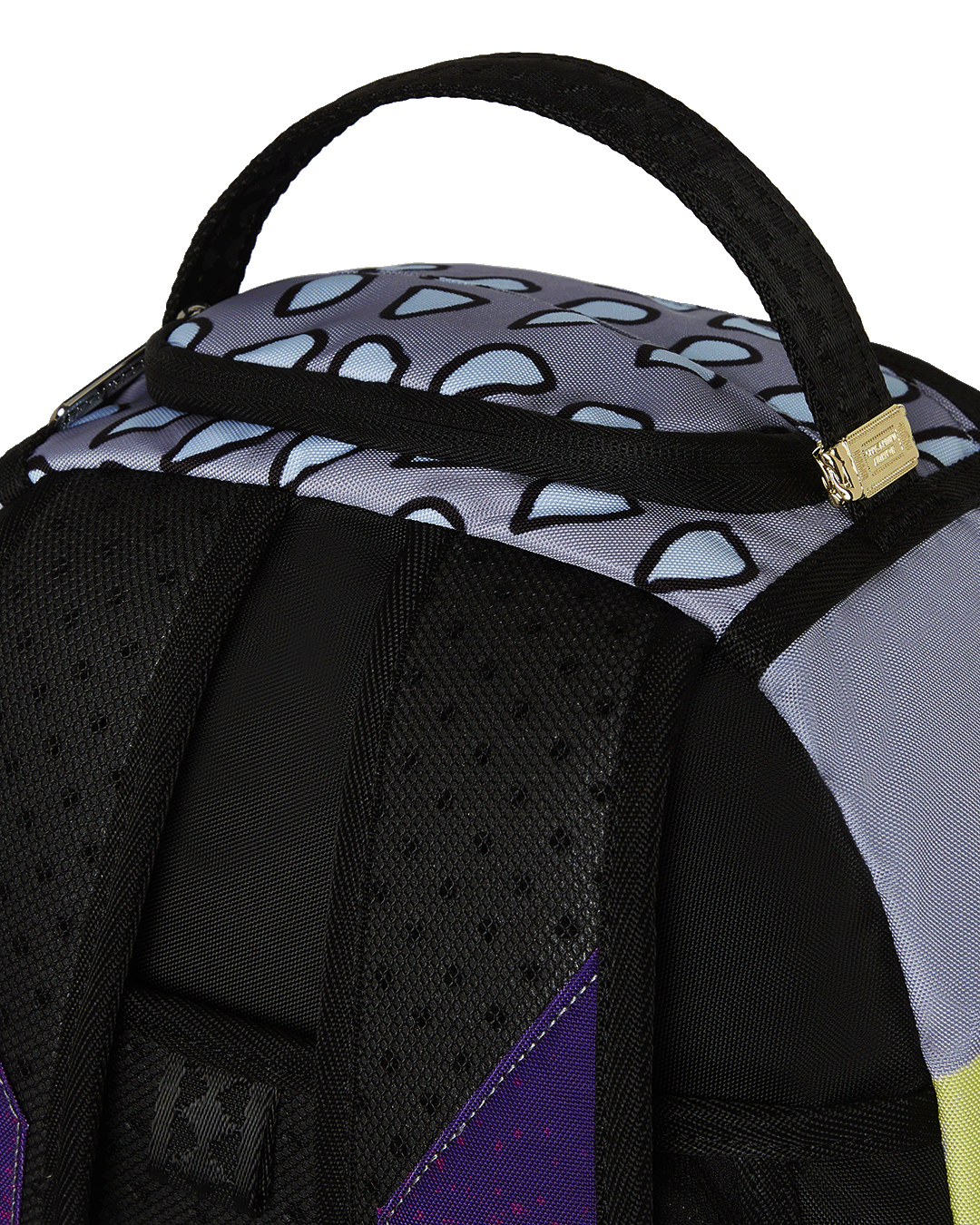 Daybreak Luxe backpack in a travel setting, attached to luggage.