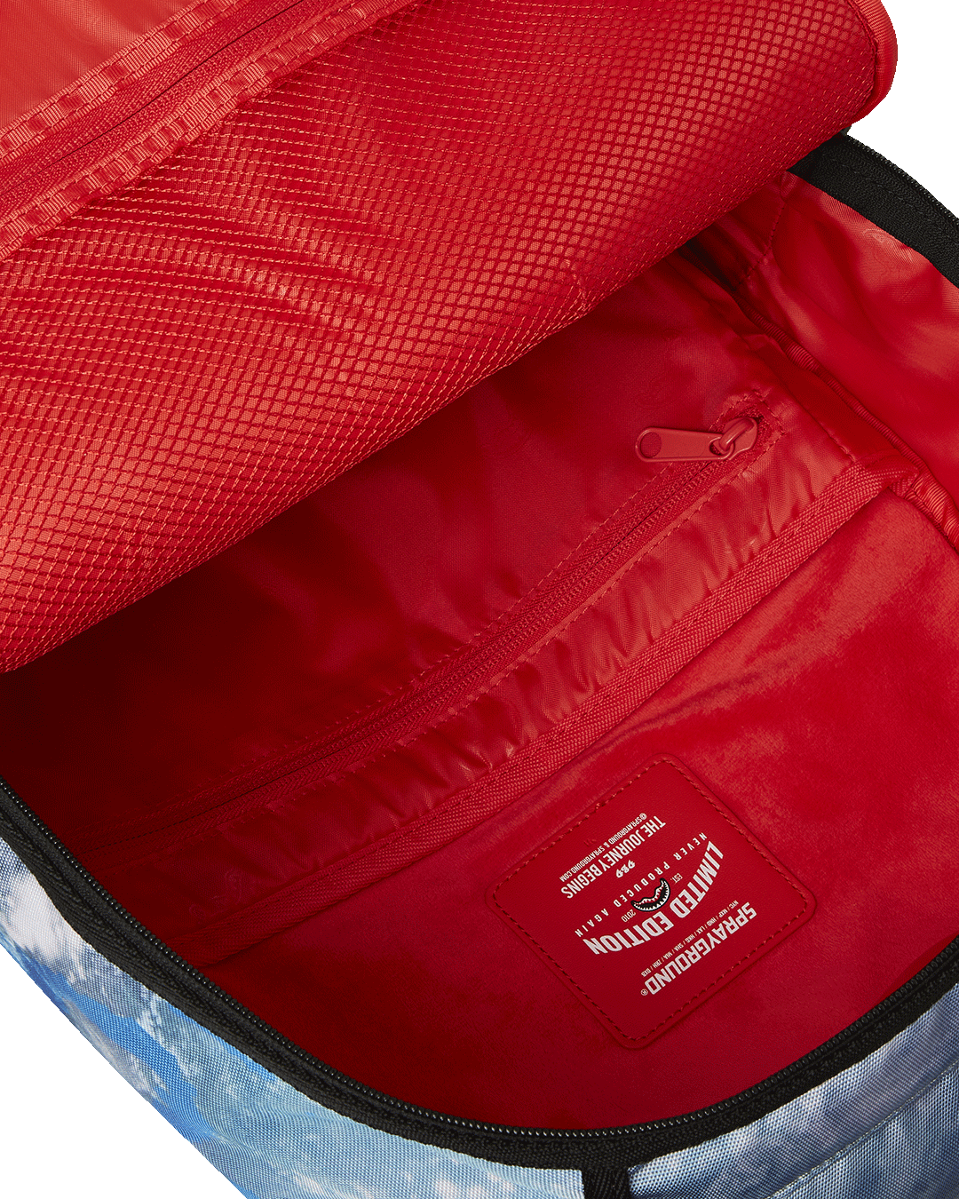 Sprayground NASA Collaboration Limited Edition Laptop Backpack in pink, with its interior laptop compartment and mesh organizer pocket visible.
