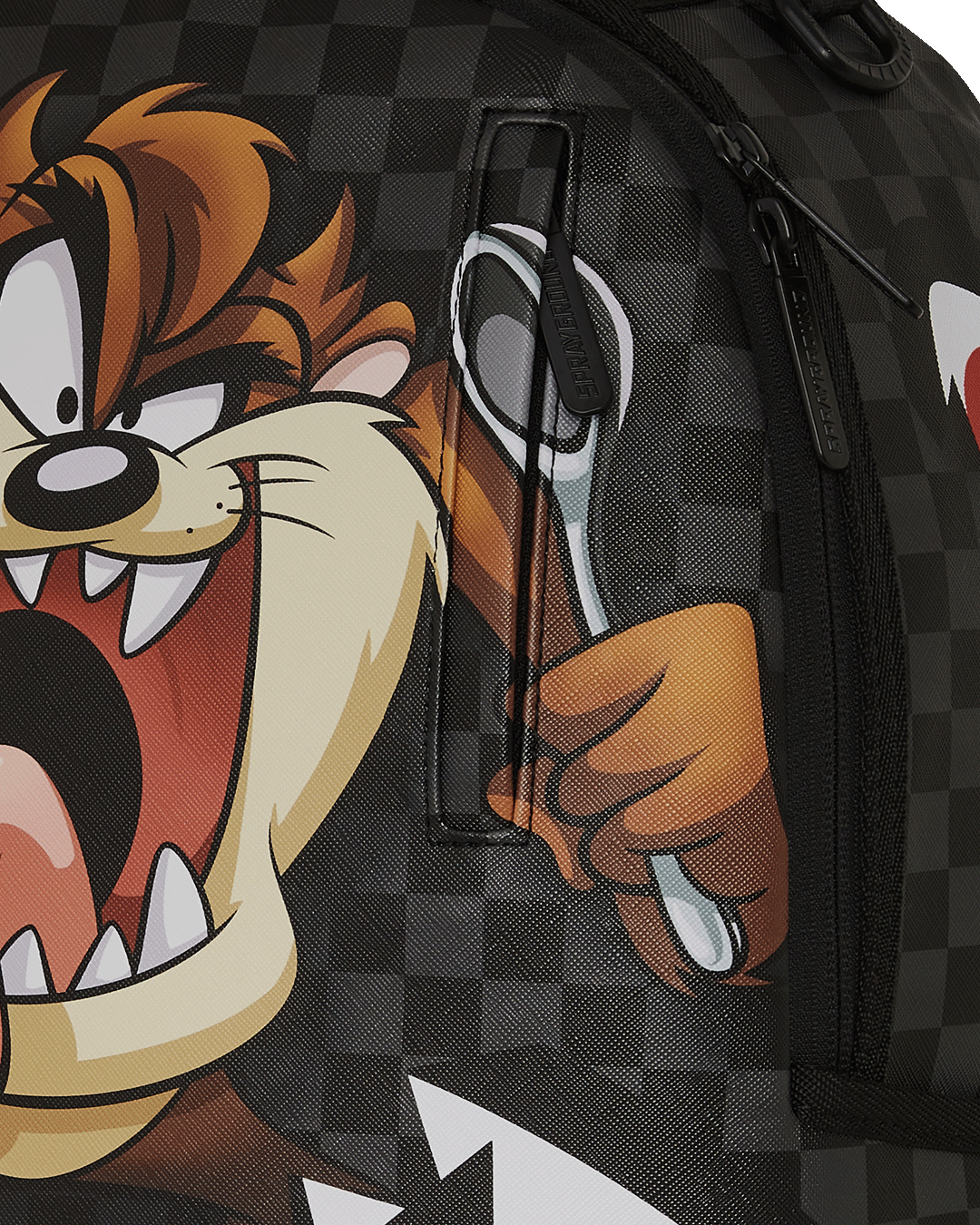 Top view of the Sprayground backpack looney tunes design with ergonomic straps and luggage sleeve