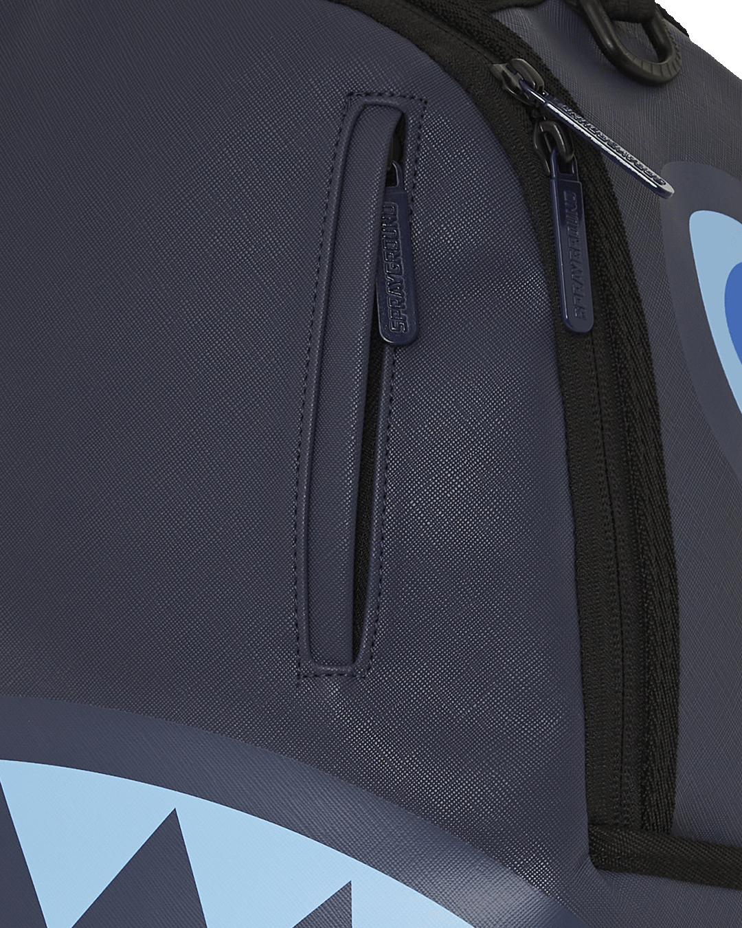 Open faux leather backpack displaying interior compartments and laptop sleeve.