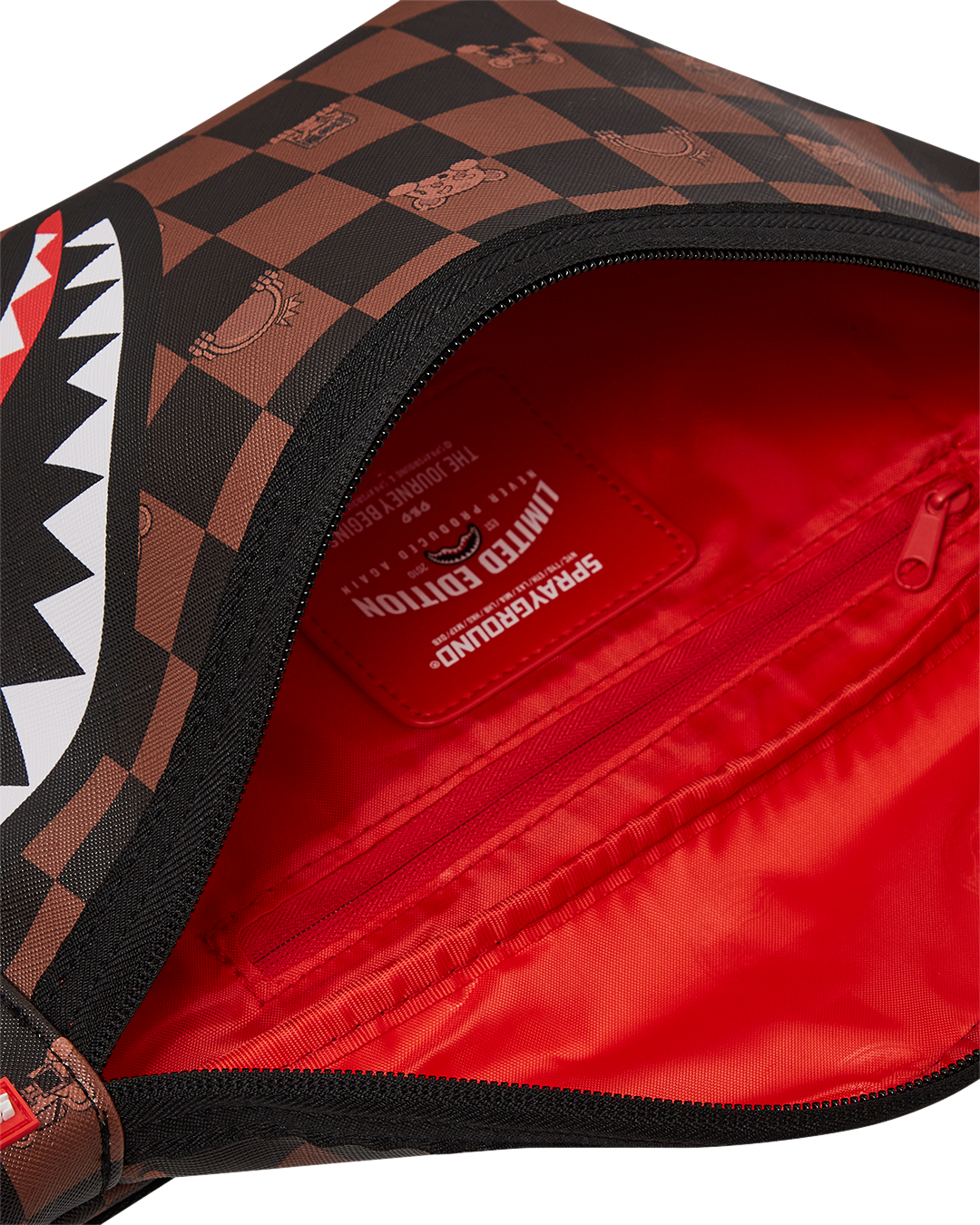 Detailed view of the bags red zippered pocket and faux leather texture