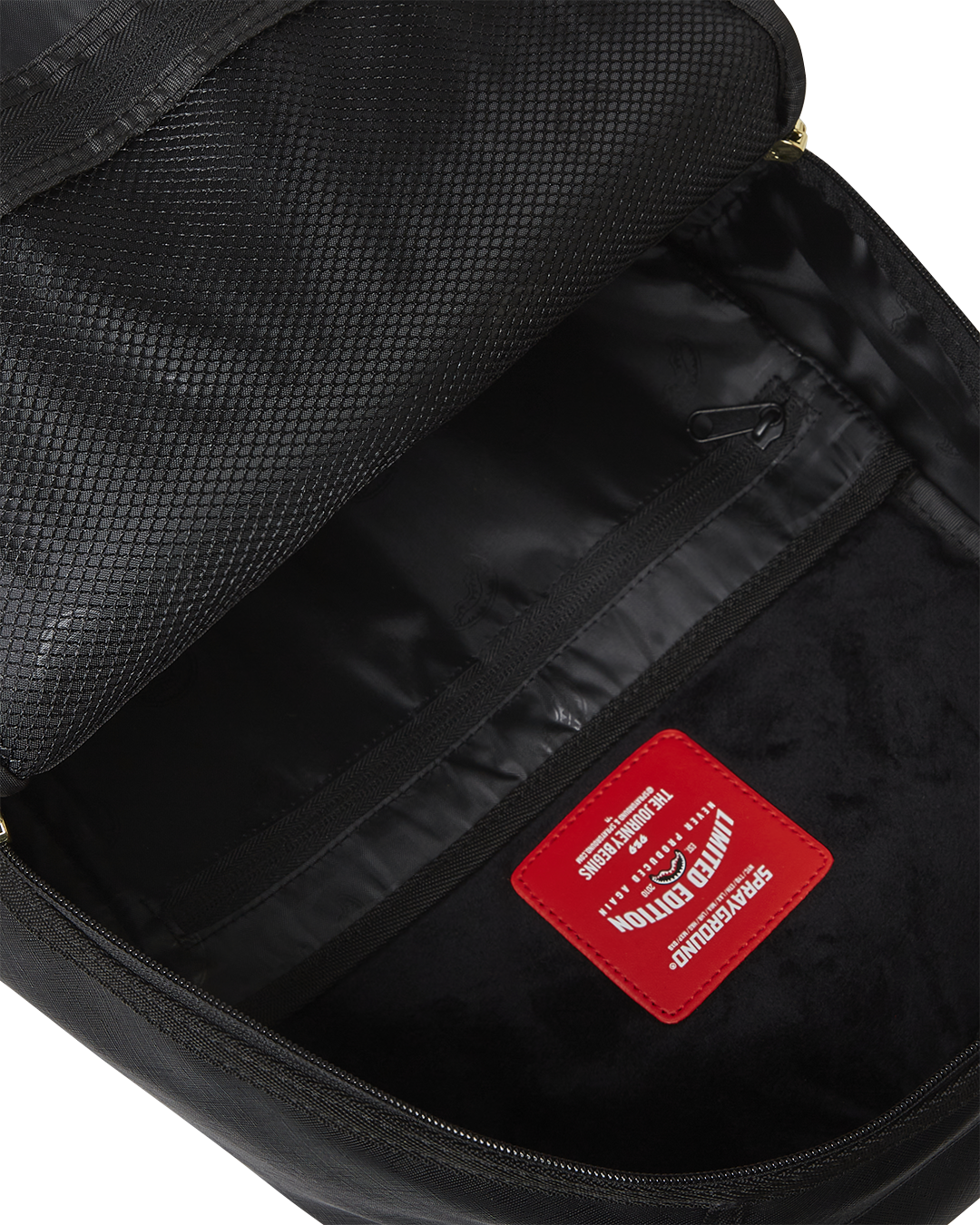 Top-down angle highlighting velour compartments and mesh-padded straps