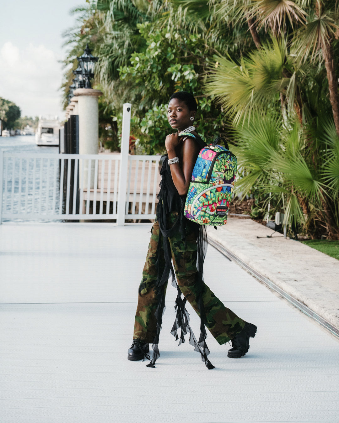 Lifestyle shot with travel backpack slid onto carry-on luggage handle, perfect for commuting.