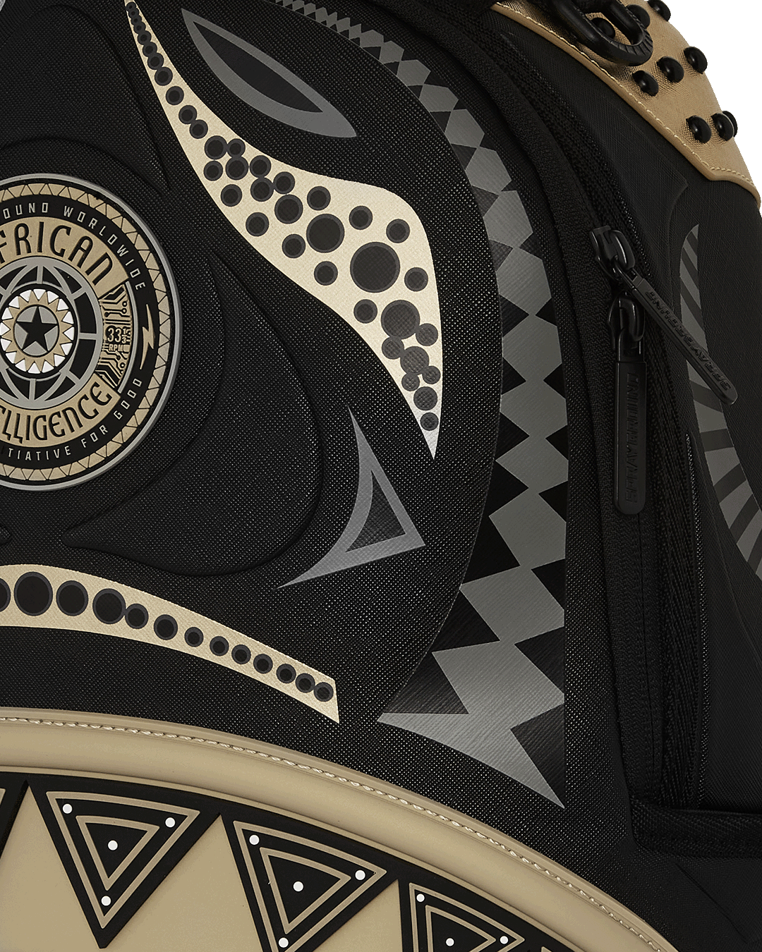 Close-up of gold zipper detailing and Sprayground badge on urban travel backpack