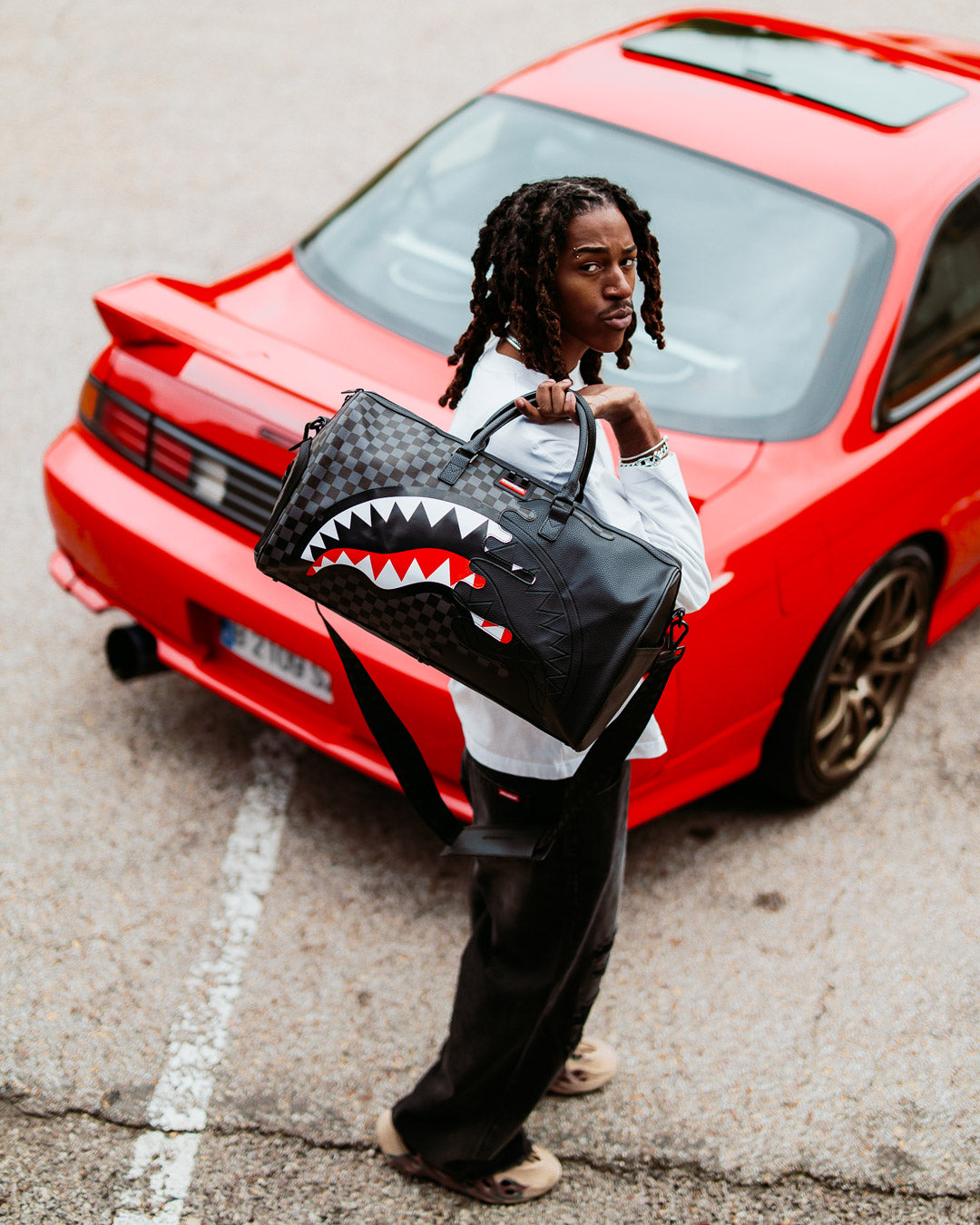 Open interior of mens duffle bag with sneaker compartment and gold zippers