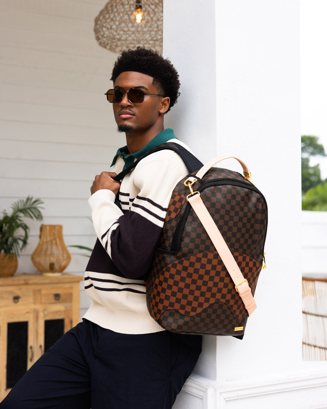 Faux leather backpack with gold zippers and multiple compartments, ideal for travel