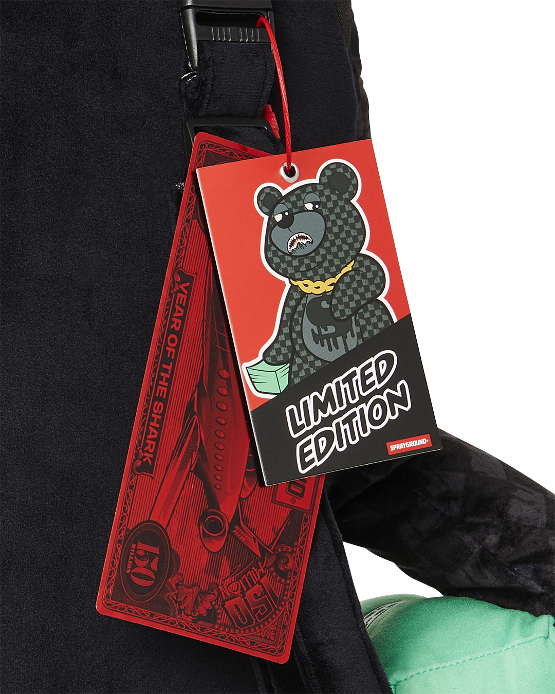 Close-up of the zippered pockets on the teddy bears belly and arm