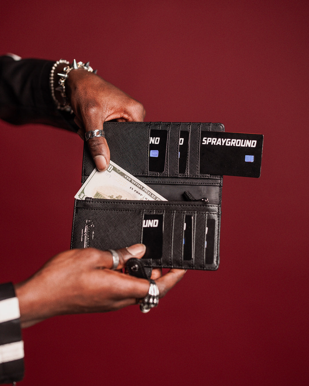 Luxury wallet closed, highlighting cut and sew detailing and elastic band closure