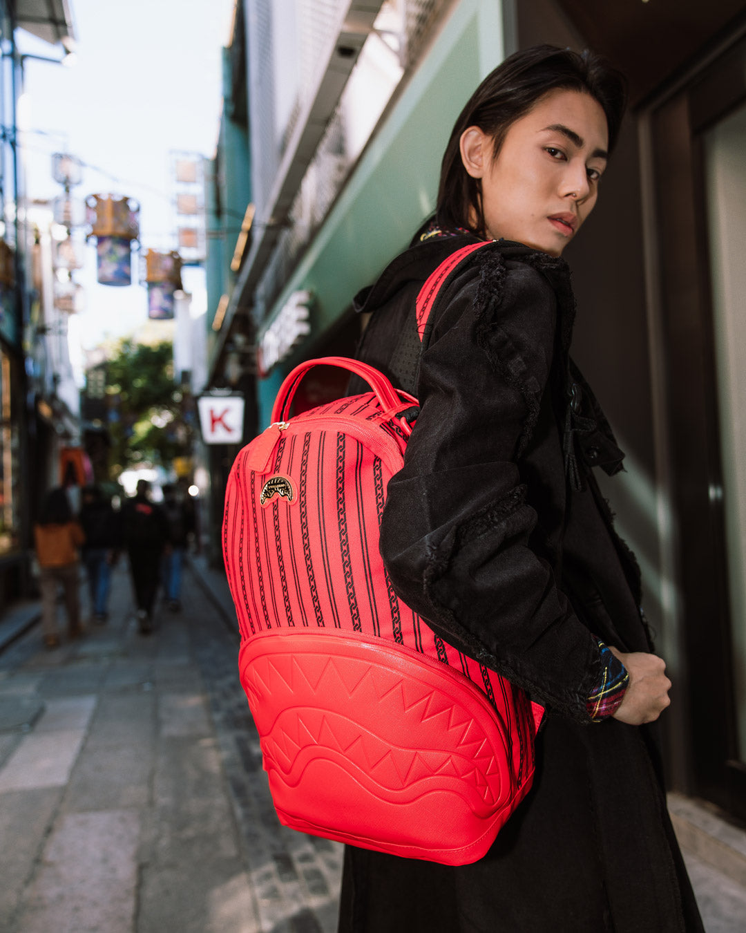 Traveler wearing the SkyChain SupplyChain backpack while hiking through a scenic trail