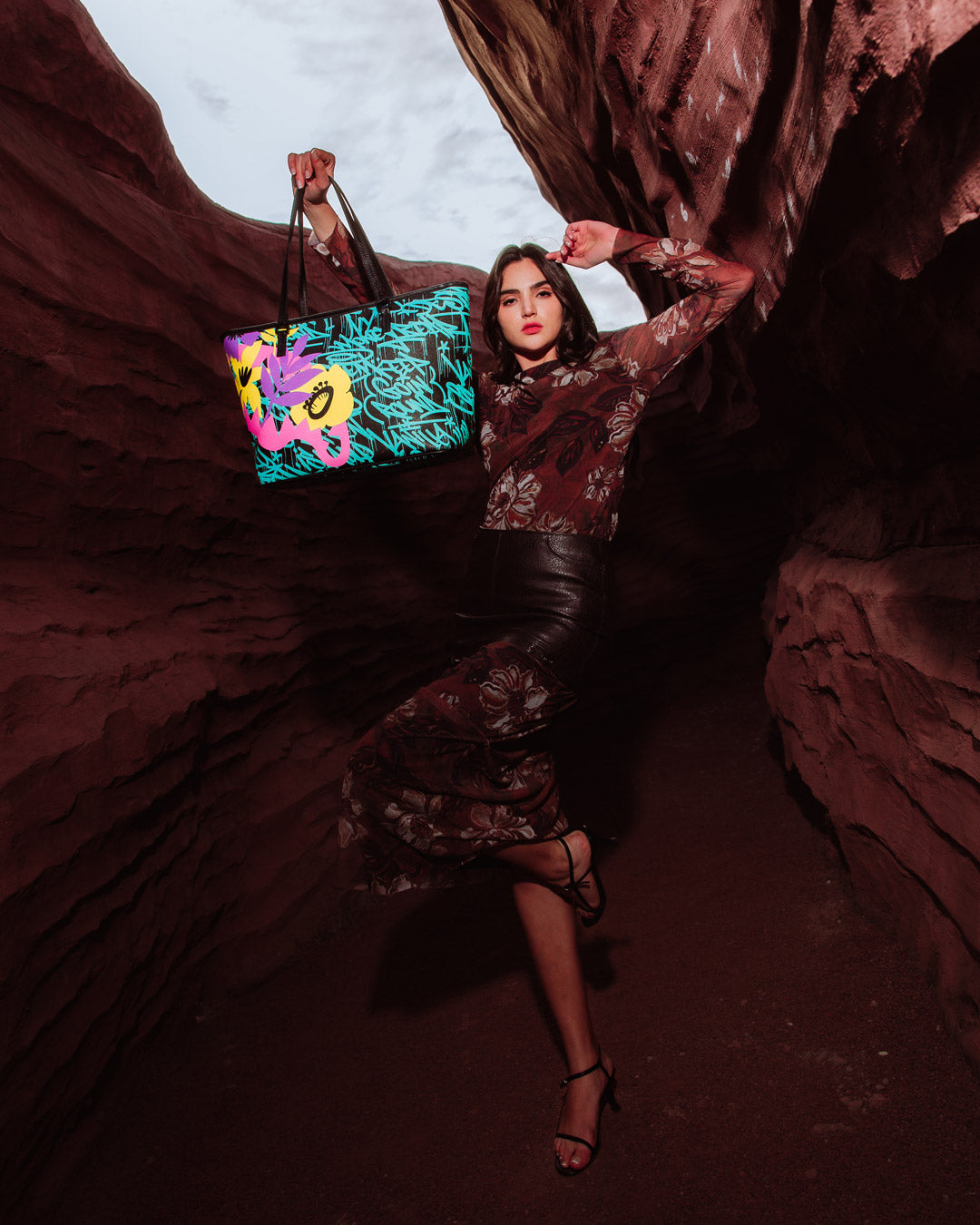 Model carrying the designer tote crossbody style with urban backdrop