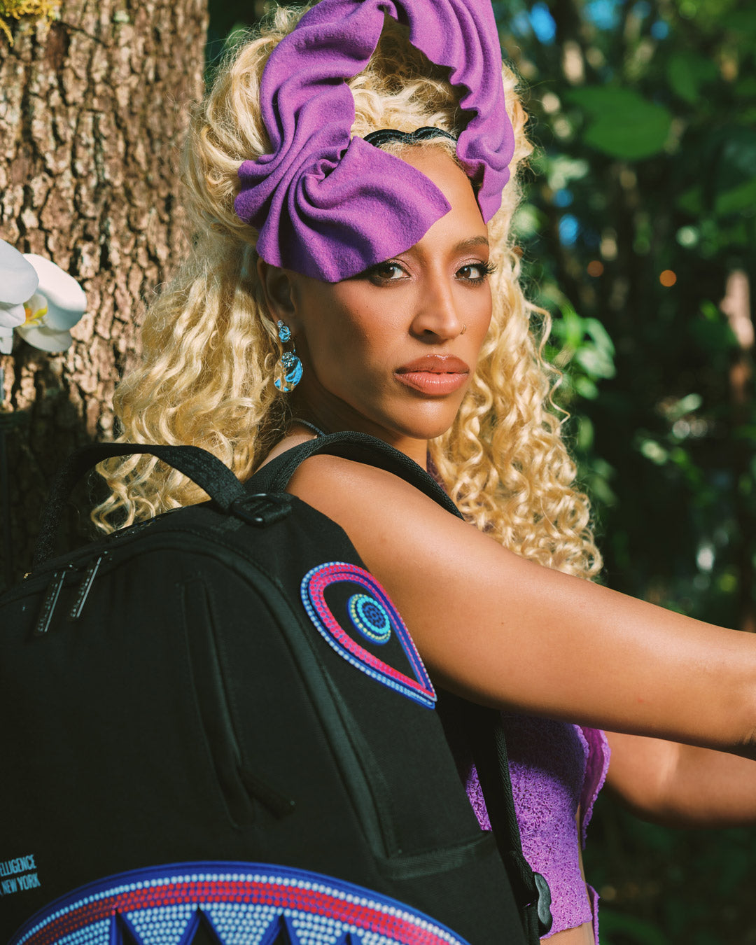Model wearing backpack with luggage sleeve attached