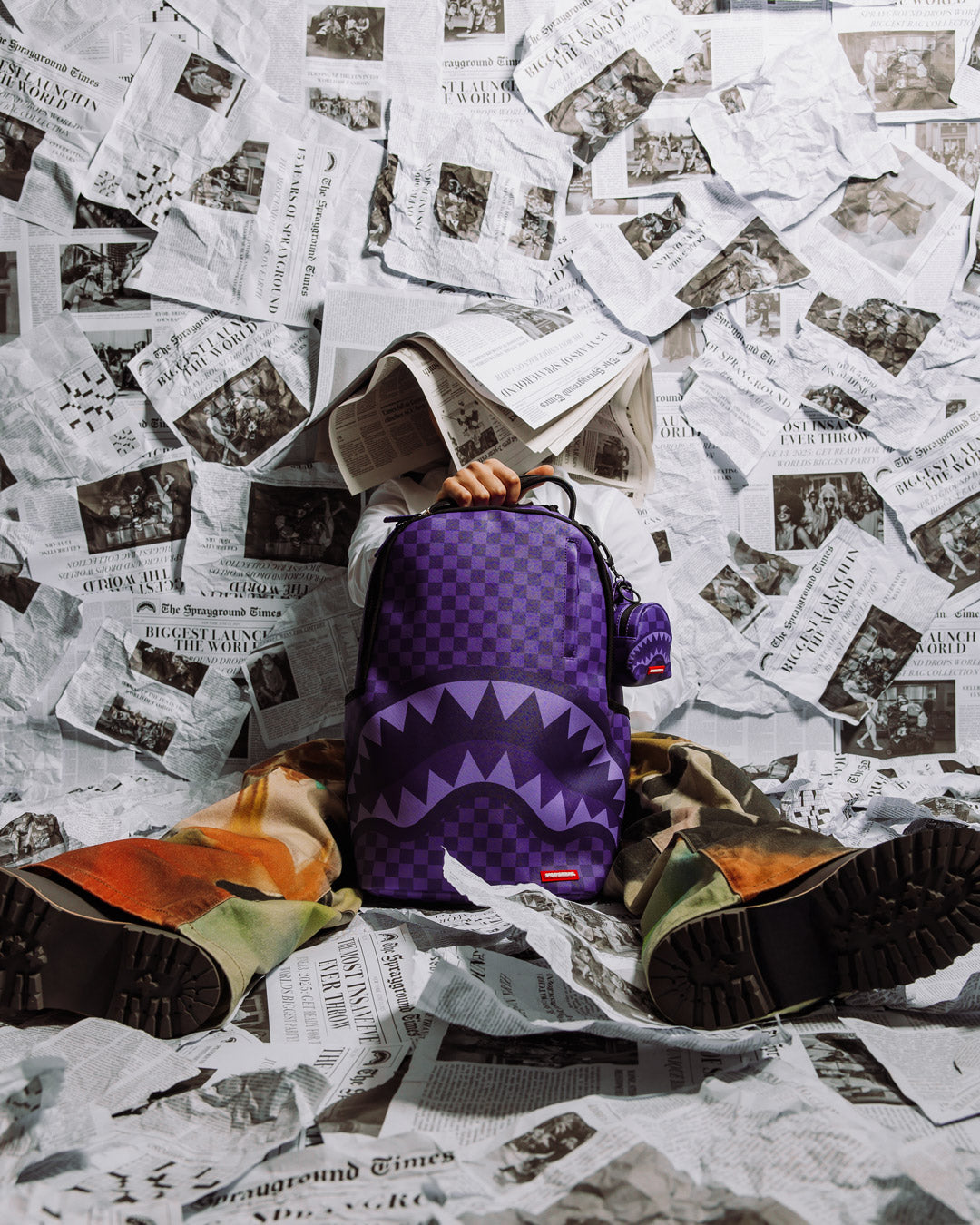 Mini backpack keychain clipped onto a casual backpack for everyday use