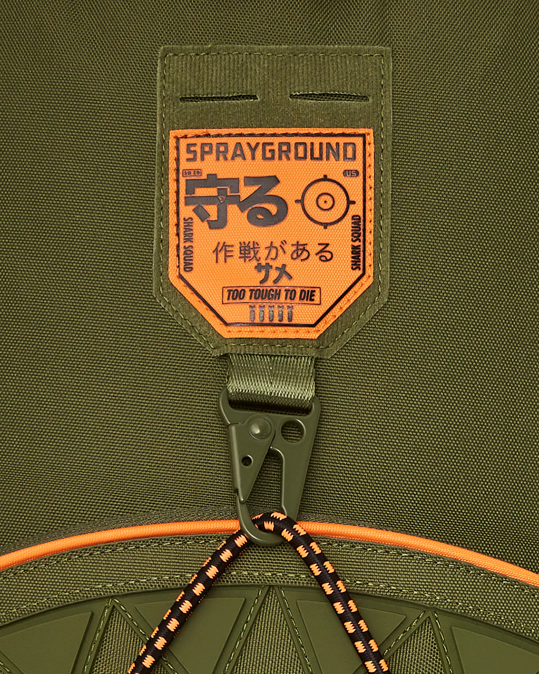 Close-up of Shark Squad tactical backpack showing organizational pockets and patches