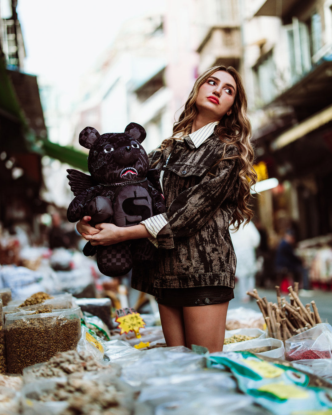 Side angle of Money Bear Backpack demonstrating adjustable straps.