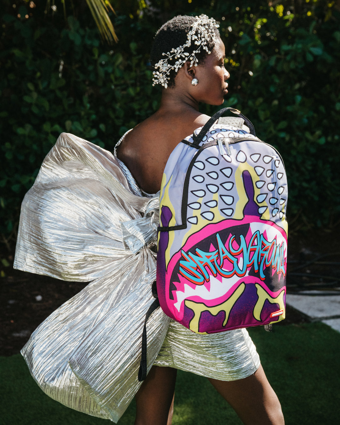 Daybreak Luxe backpack with front zipper pocket and side pockets.