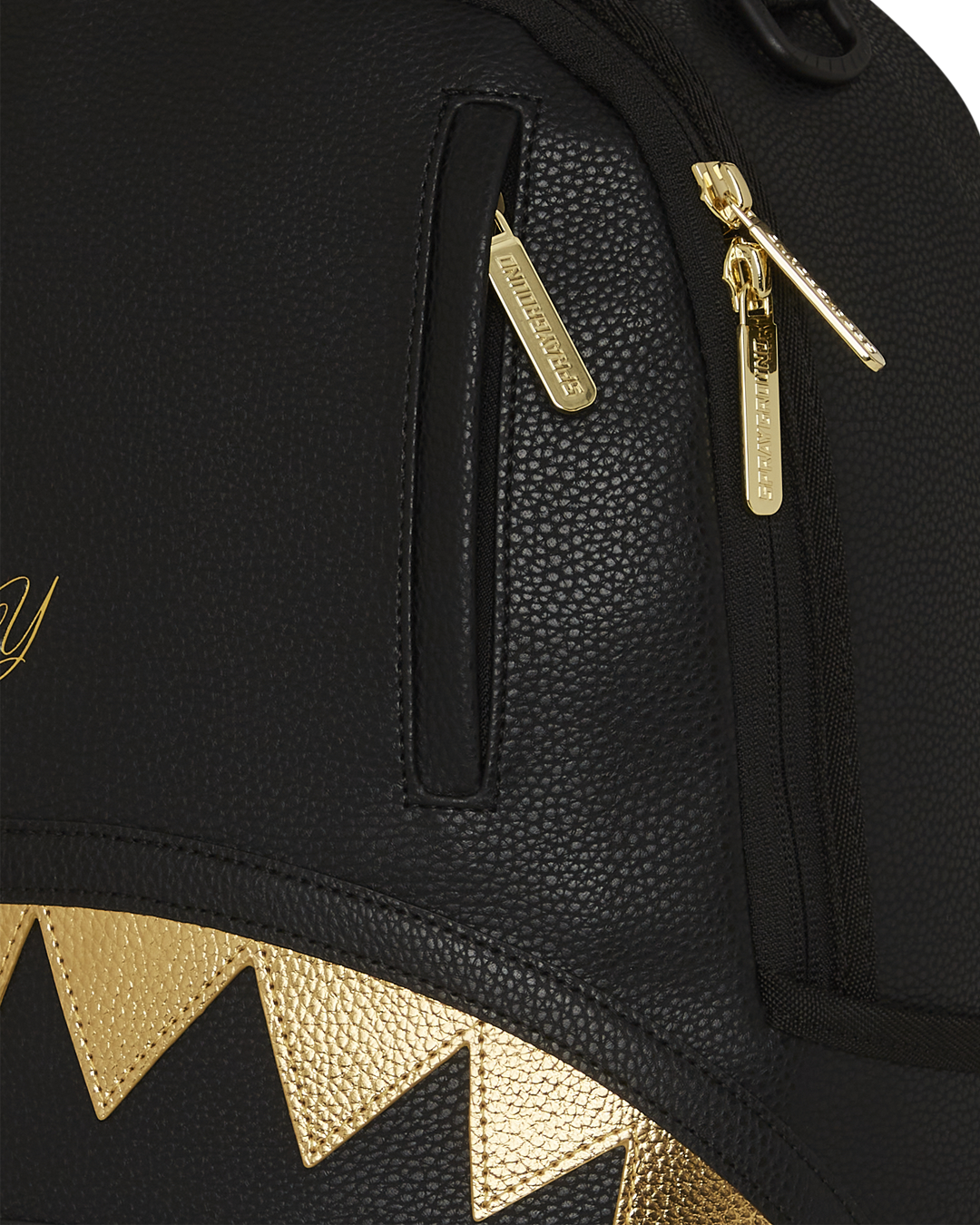 BAPE Shark backpack with faux leather finish and gold accents, interior view showing laptop compartment