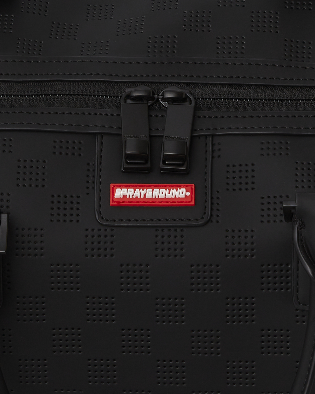 Front view of the designer duffle bag with shark mouth detail and gold zippers